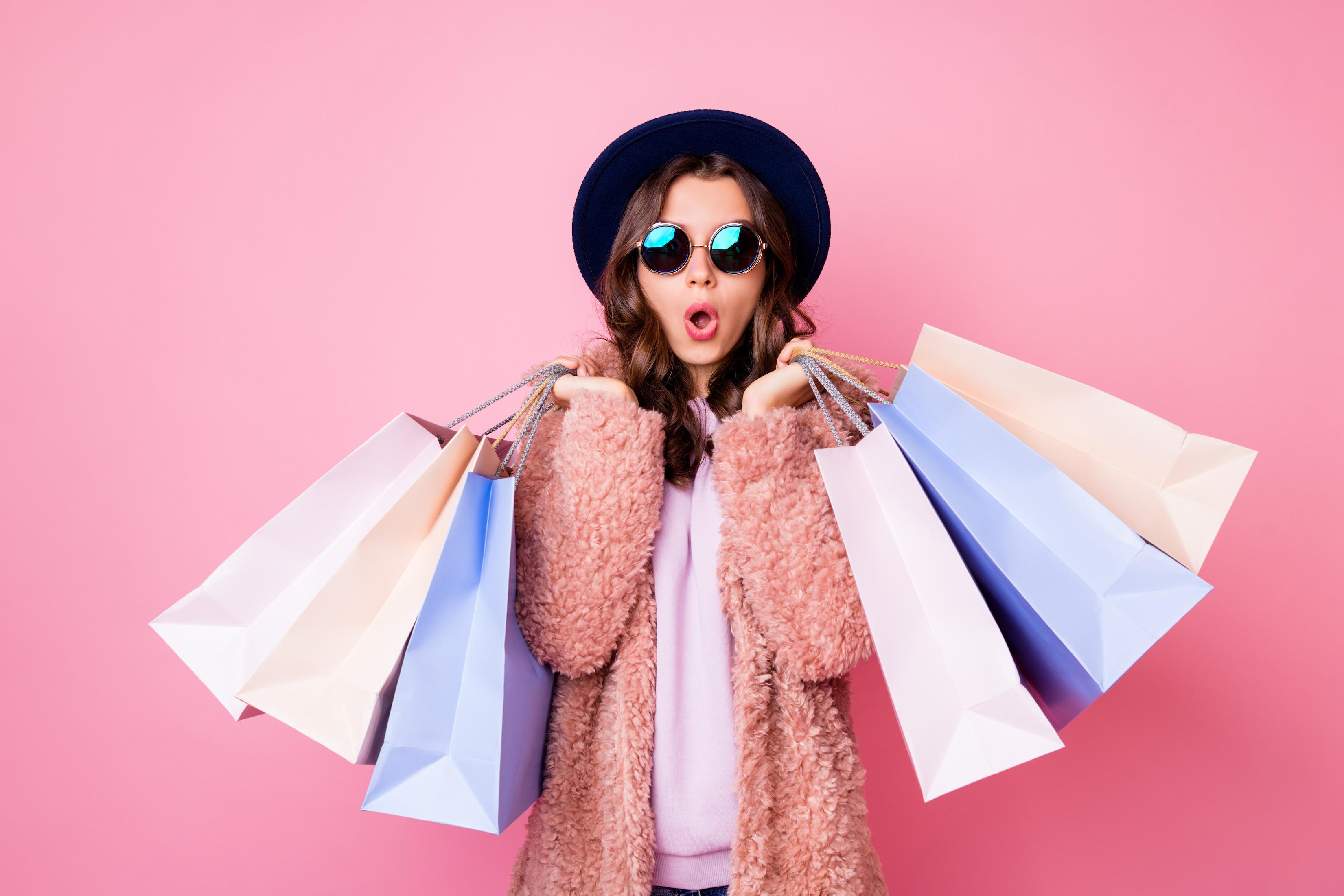 A woman holding several shopping bags.